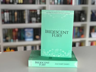 Two advanced reader copes of Iridescent Fury by Zachary James.