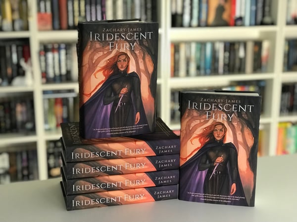 A stack of several copies of self-published fantasy novel Iridescent Fury.