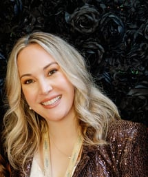 Author Stacia Stark who has blonde hair, brown eyes and is smiling widely.